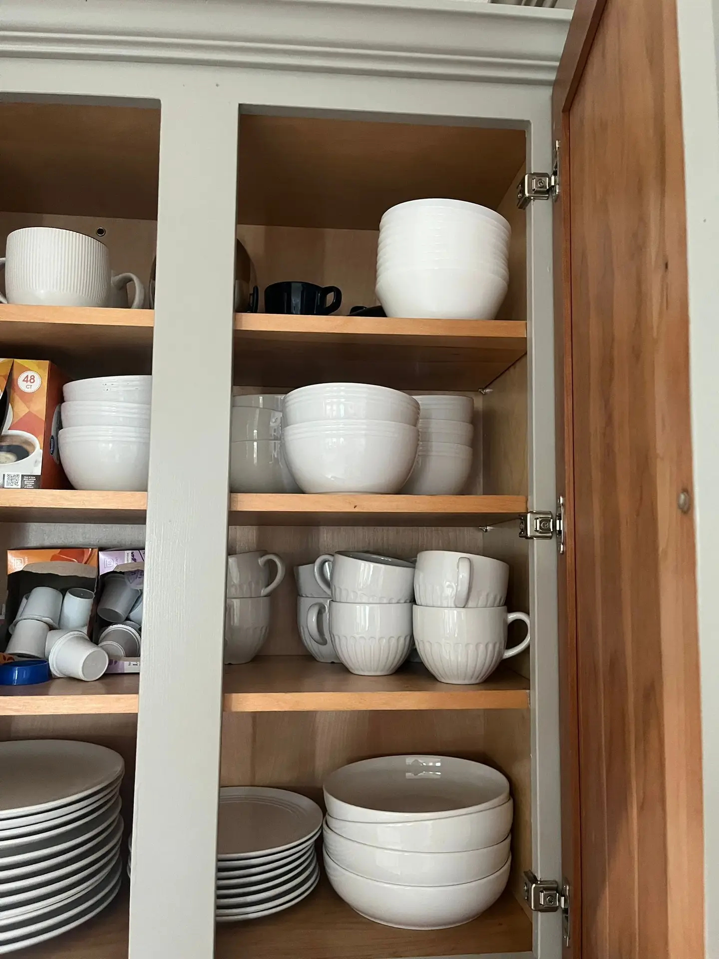 cups and saucers in kitchen cupboard